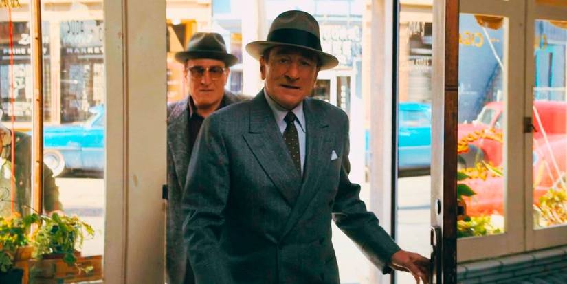 Robert De Niro as both Vito Genovese and Frank Costello walk into a shop in The Alto Knights.
