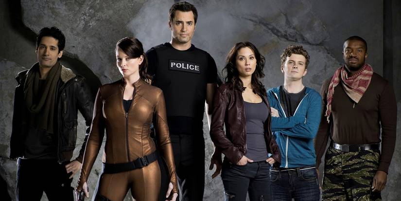 The cast of Continuum with a gray background looking at the camera.