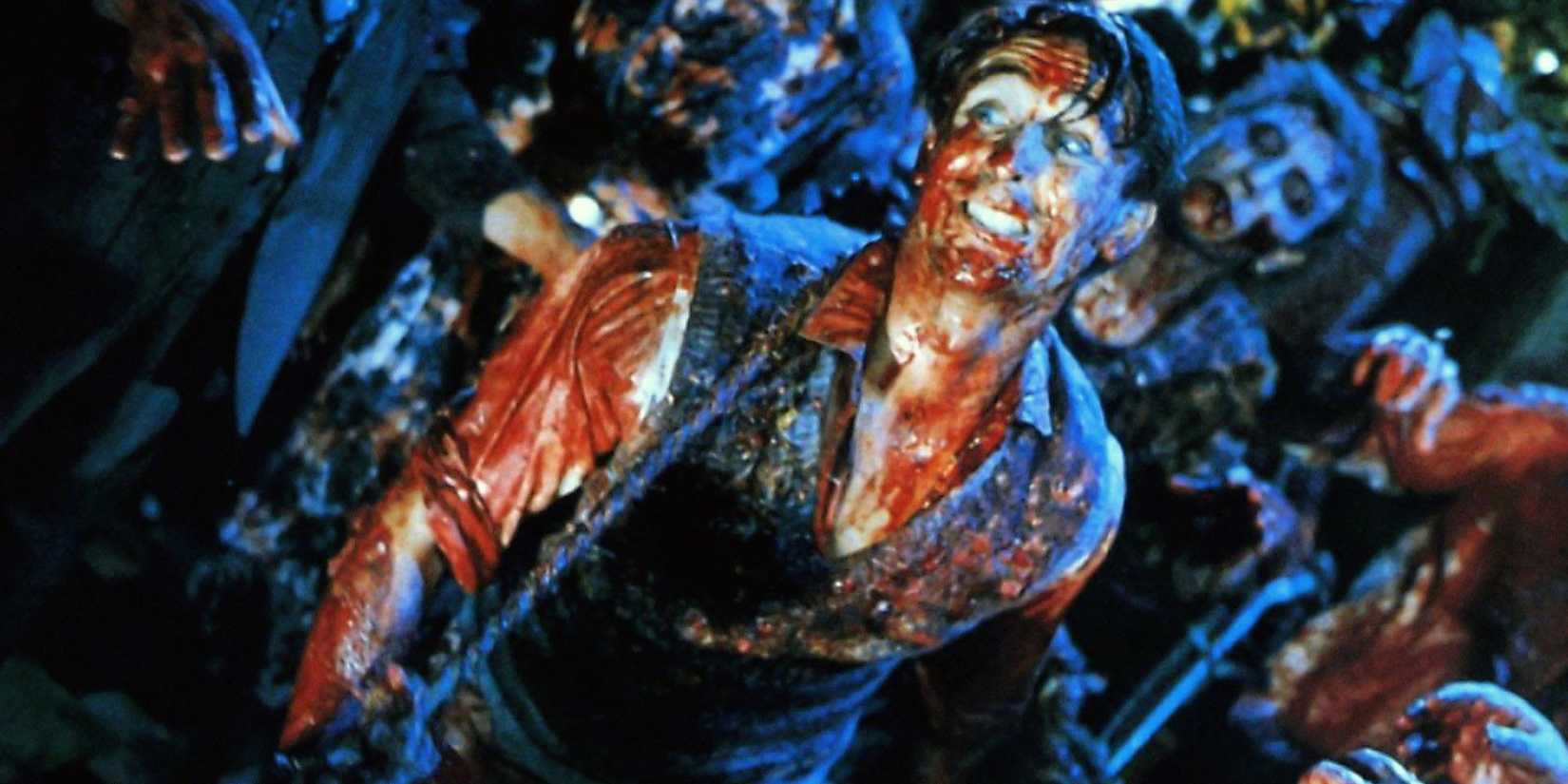 A man covered in blood escaping from a horde of zombies in Braindead - 1992