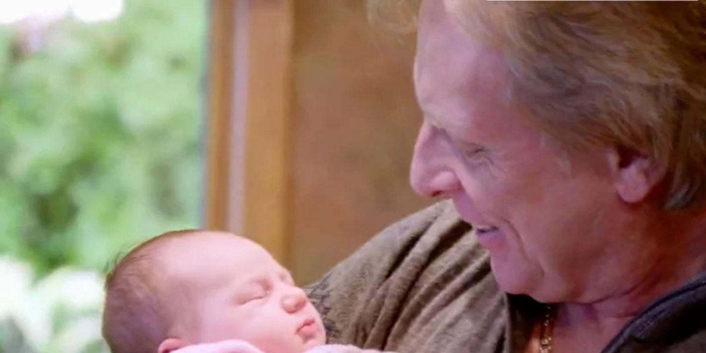Captain Sig Hansen holds his newborn granddaughter and smiles on 'Deadliest Catch.'