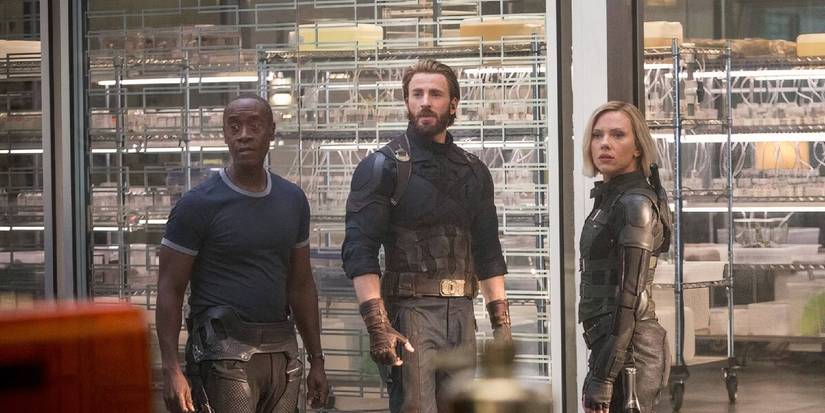 Don Cheadle as Rhodey, Chris Evans as Steve Rogers and Scarlett Johansson as Natasha Romanoff standing looking into the distance in Avengers Infinity War.