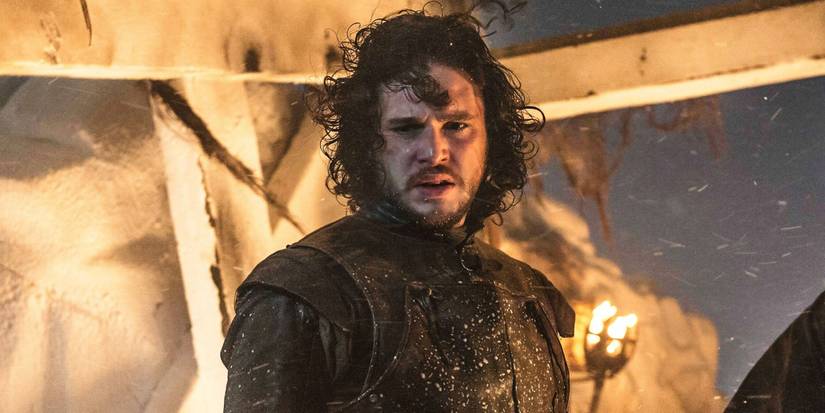 Kit Harington as Jon Snow looking to the distance amidst a battle in Game of Thrones.