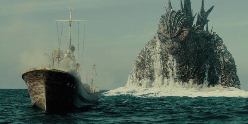 Godzilla sort de l'océan derrière un bateau de pêche à Godzilla moins un.