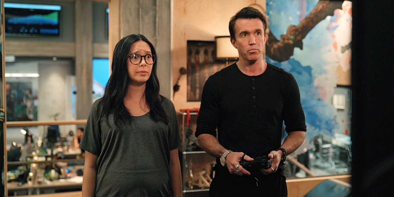 Poppy Li and Ian Grimm looking at a TV together in Mythic Quest Season 4.