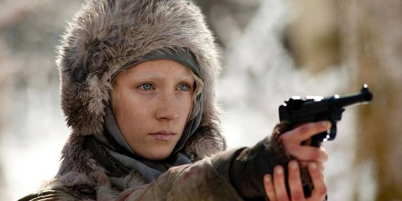 Saoirse Ronan with bleached eyebrows holding a small gun in the 2011 action film Hanna.