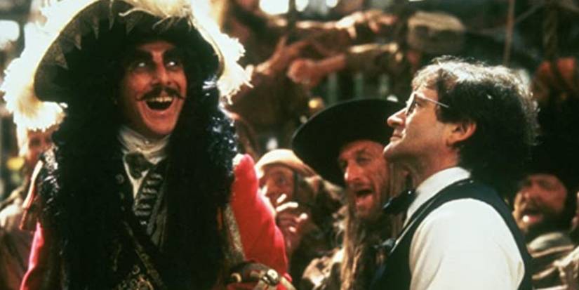 Hook still with Dustin Hoffman as Hook laughing in a crowd near Robin Williams