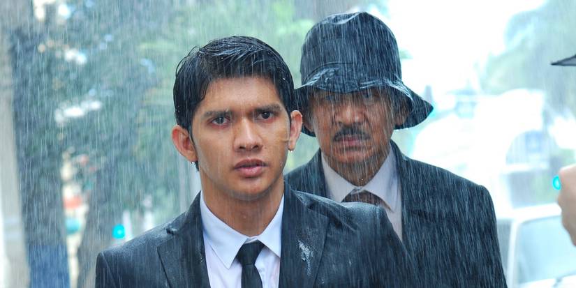 Iko Uwais standing under the rain in The Raid 2
