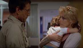 Martin Brody (Roy Scheider) talking to Ellen Brody (Lorraine Gray) holding her son in a hospital in 'Jaws'