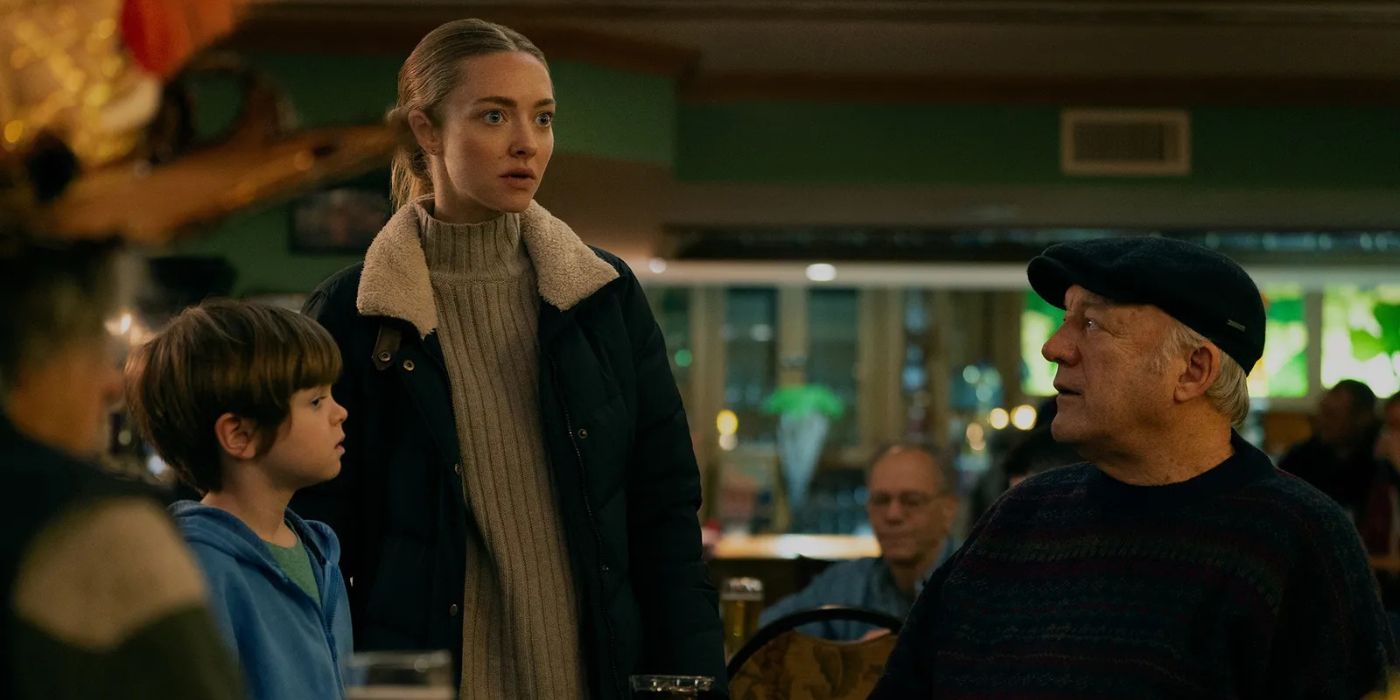 Mickey (Amanda Seyfried) standing next to Thomas (Callum Vinson) and G-Pop (John Doman) in Long Bright River.