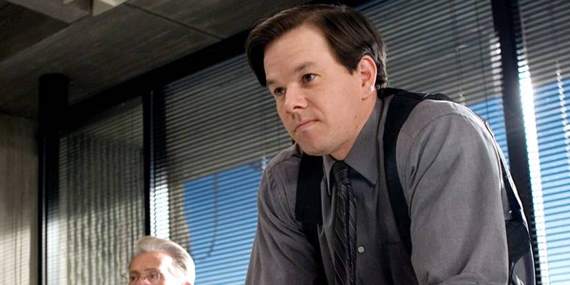 Mark Wahlberg as Sean Dignam smiling mischievously in the police office in The Departed