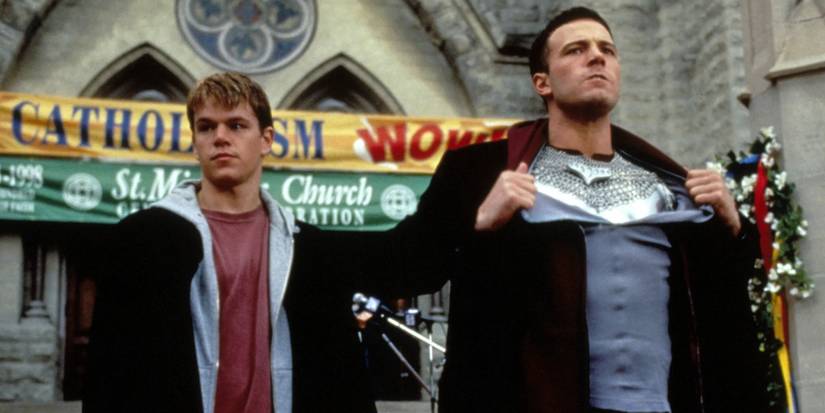 Ben Affleck as Bartleby ripping off his close to reveal armor standing next to Matt Damon as Loki in Dogma