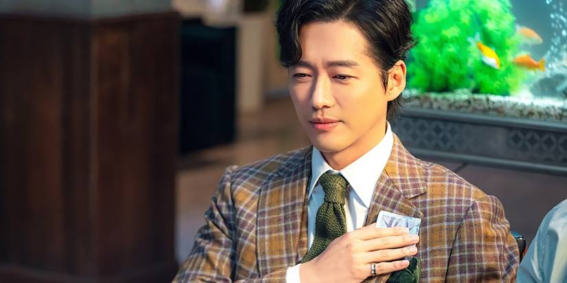 Min Nam-koong as Chun Ji-hoon in One Dollar Lawyer, wearing a plaid jacket and pledging with his right hand on the left side of his chest