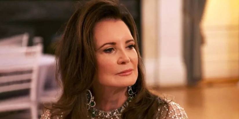 Patricia Altschul in a nice outfit and jewelry looks intently at something off-camrea in Southern Charm.