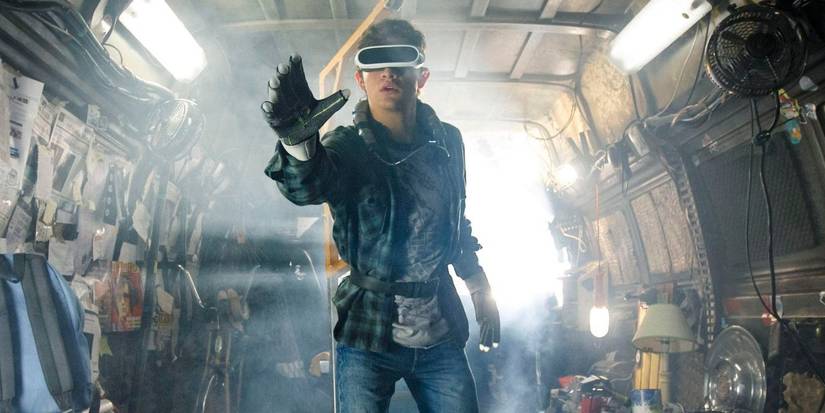 Tye Sheridan as Wade Watts / Parzival standing with a gloved hand out in Ready Player One