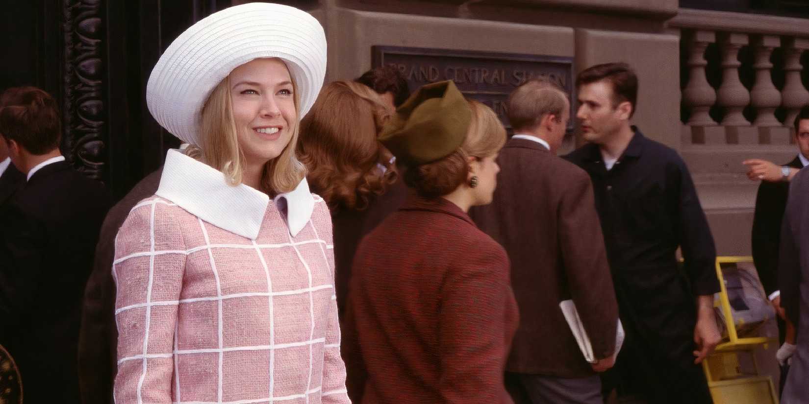 Renée Zellweger in Down With Love smiling while standing on the street.