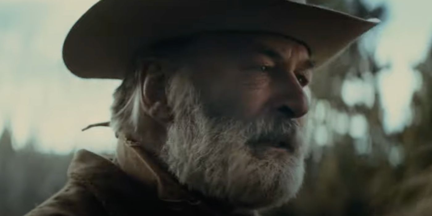 alec baldwin wears a cowboy hat and a gray beard in rust