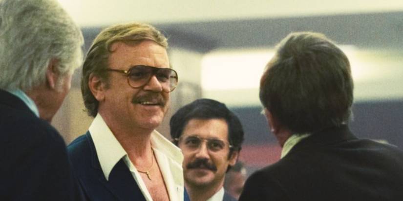John C. Reilly as Jerry Buss wearing a blue suit and white unbuttoned shirt in 'Winning Time'