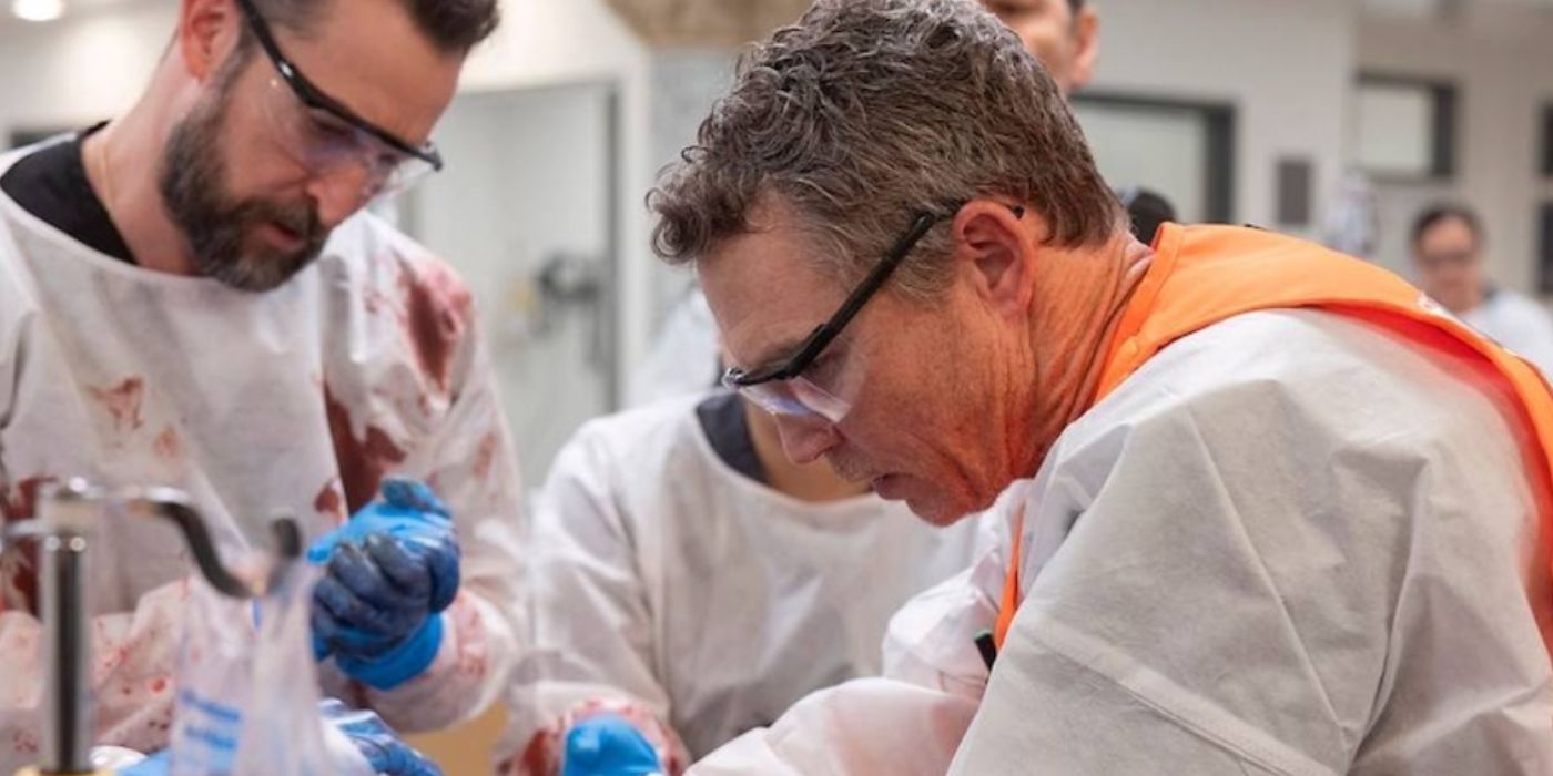 Shawn Hatosy as Dr. Abbott wearing white scrubs and orange vest in 'The Pitt.'