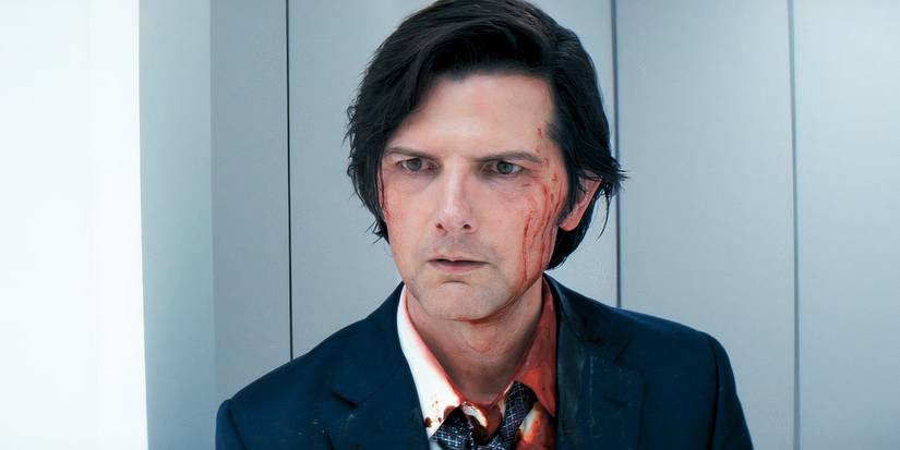 Adam Scott as Mark, looking serious with blood on his face in the Severance Season 2 Finale.