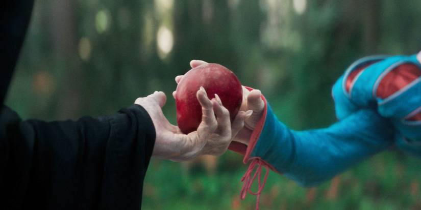 The Evil Queen handing Snow White an apple in Snow White