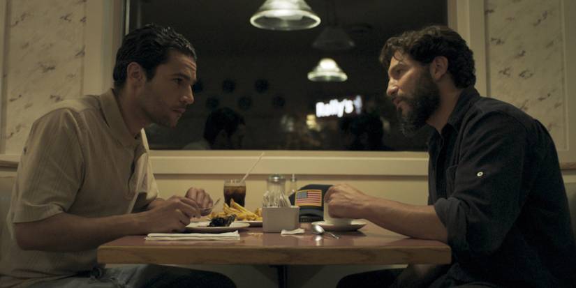 Elwood (Abbott) and Sam (Bernthal) sitting at a diner in Sweet Virginia.