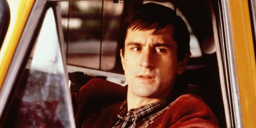 Robert DeNiro as Travis Bickle looking angrily out of his taxi cab window in Taxi Driver.