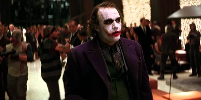 Heath Ledger as the Joker taking over a party with his henchmen in The Dark Knight.
