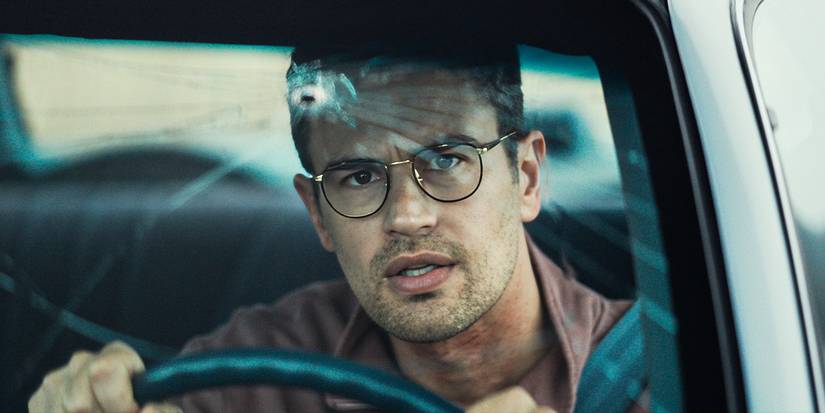 Theo James looks at his cracked windshield in The Monkey