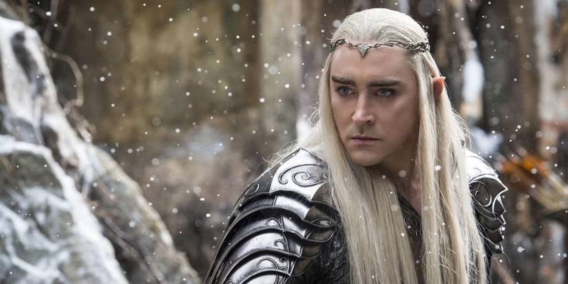 Lee Pace as Thranduil staring intently in armor as snow falls in The Hobbit