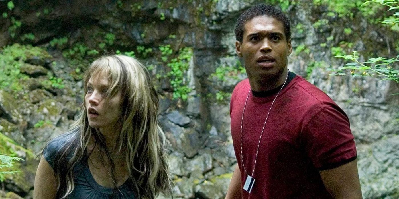 Erica Leerhsen as Nina Papas and Texas Battle as Jake Washington look out from the rocks in Wrong Turn 2
