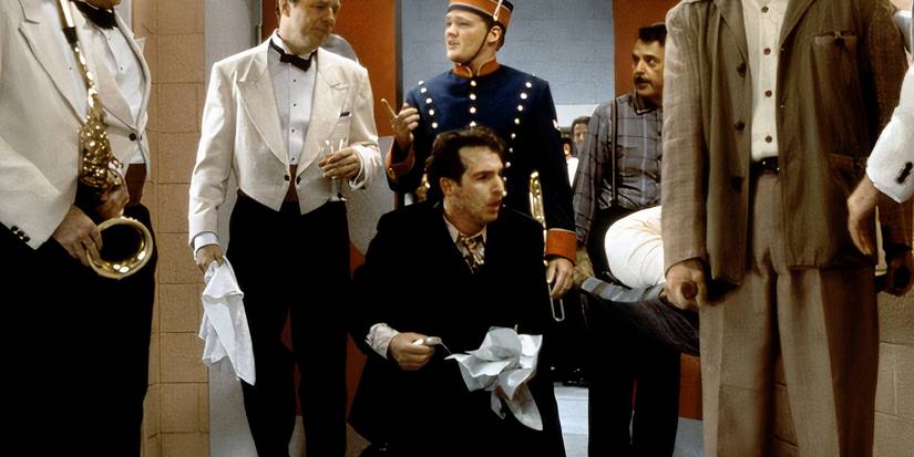 Brian Benben looks disheveled amongst a crowd in Radioland Murders