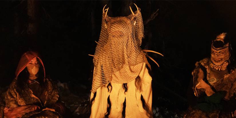 The Antler Queen sitting around a fire with the girls in Yellowjackets Season 1, Episode 10