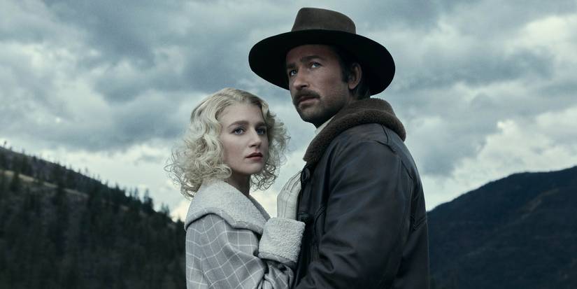 Spencer and Alex standing close together looking into the distance with mountains behind in 1923.