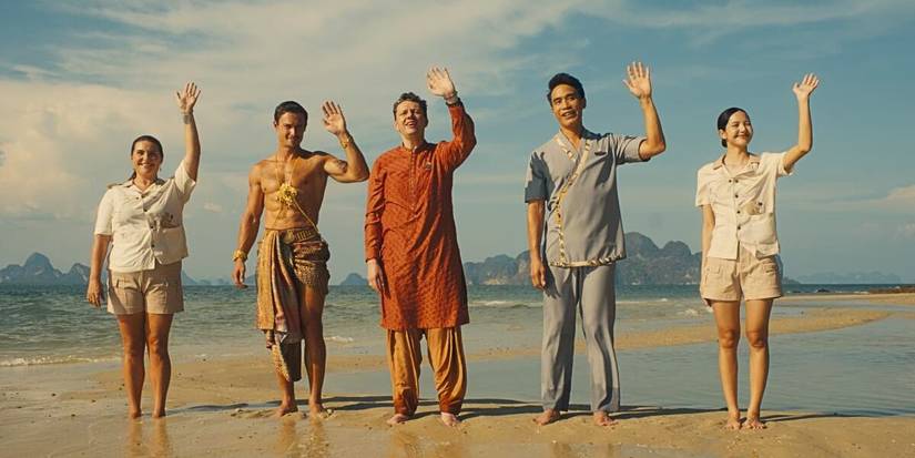 The staff of The White Lotus in Thailand waving on a beach in The White Lotus Season 3.