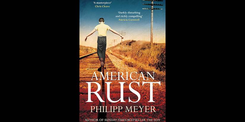 Boy walking across train tracks in Cover of 'American Rust' by Philipp Meyer