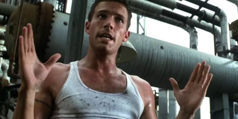 Ben Affleck talks to someone off-screen and gestures with his hands on an oil rig in Armageddon.
