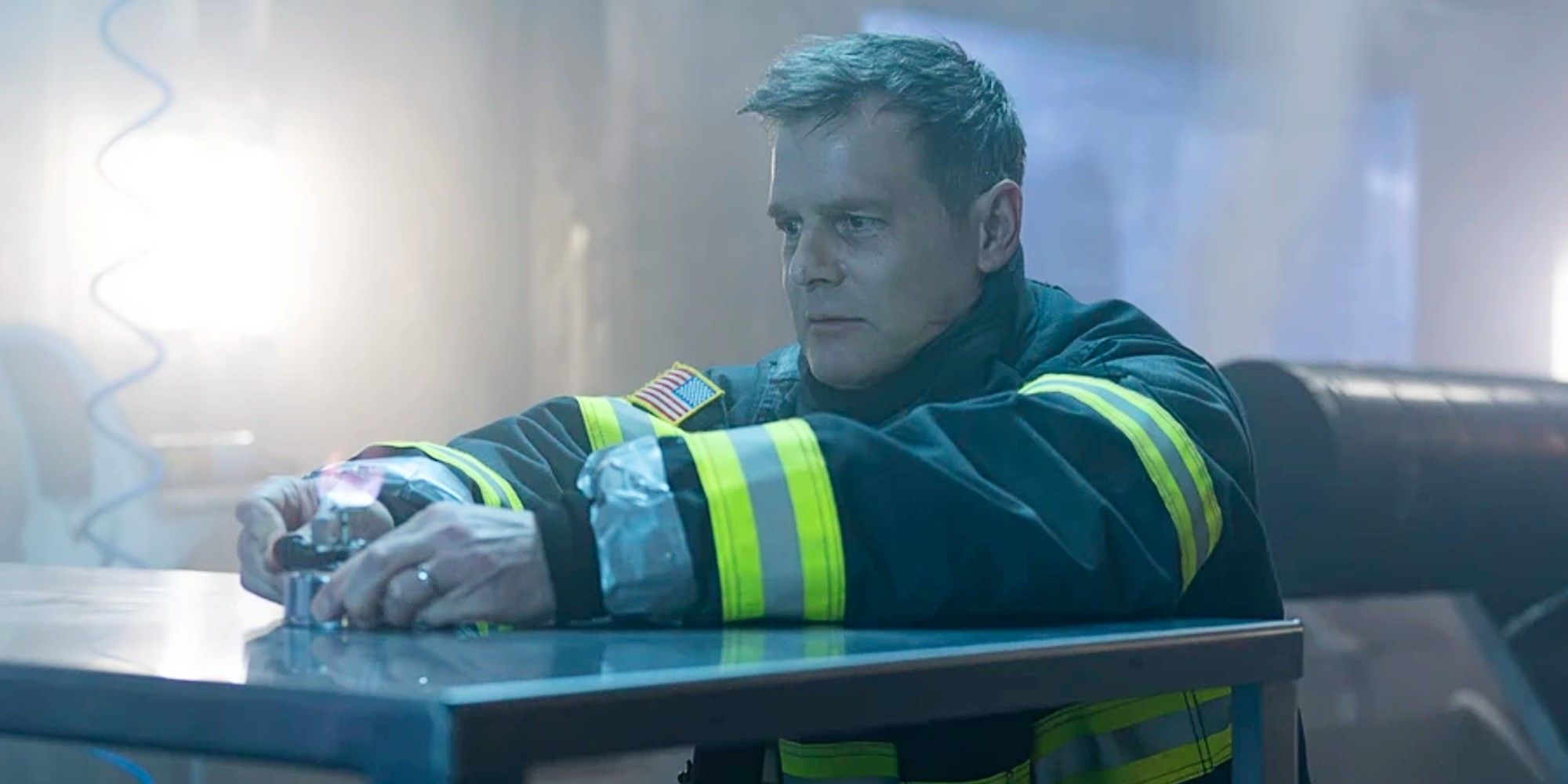 Bobby Nash sitting at a lab table while dying alone in 9-1-1.