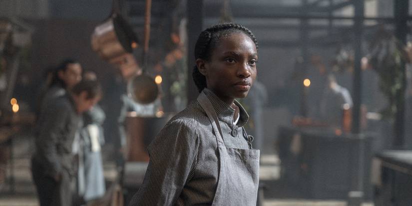 Agathe (Alice Da Luz) standing in the kitchen in Carême