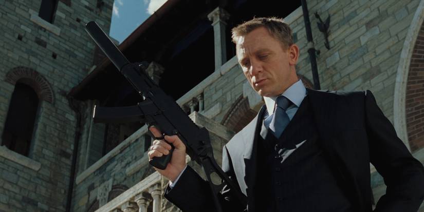 James Bond holding a gun and looking down at something in Casino Royale