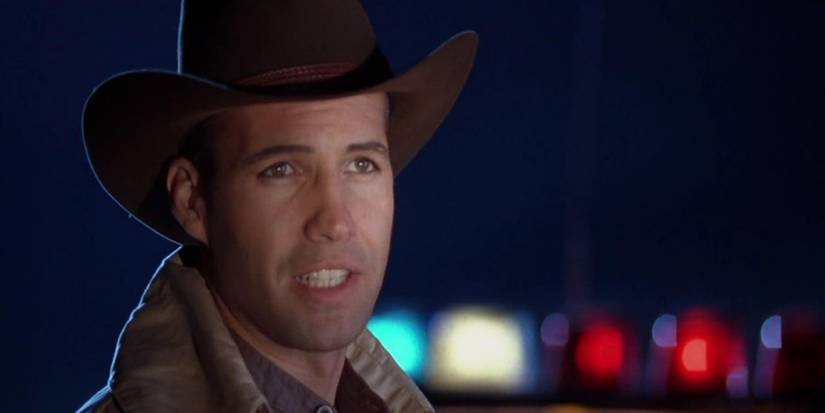 Billy Zane looks off-camera while wearing a cowboy hat in Demon Knight.
