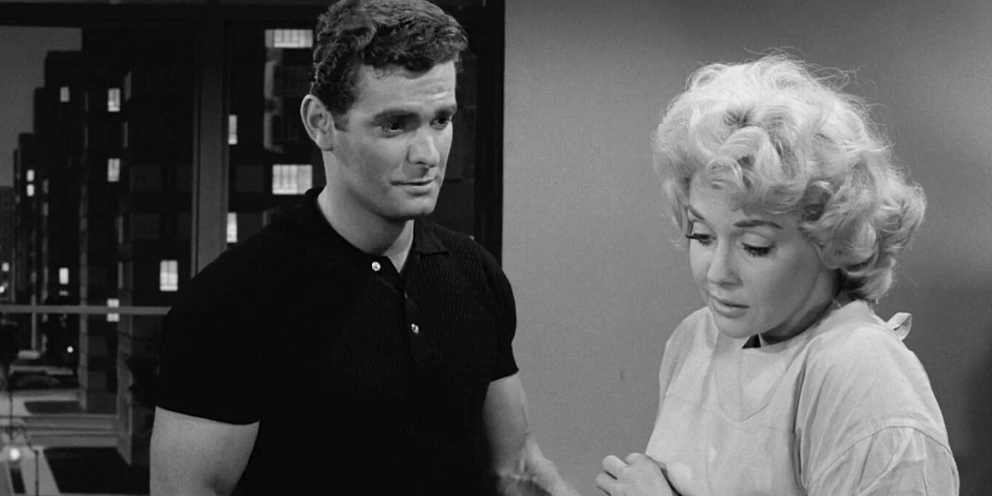 Edson Stroll standing in front of Donna Douglas in The Twilight Zone episode Eye of the Beholder