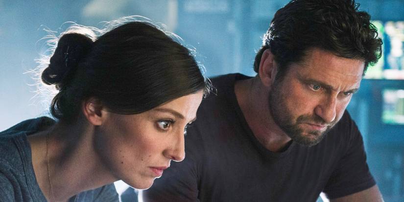 Gerard Butler's Jake and Alexandra Maria Lara's Ute studying something in Geostorm