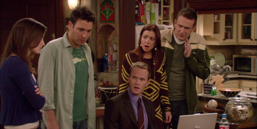 Barney (Neil Patrick Harris) sits behind a laptop with a stunned expression as Ted (Josh Radnor), Lily (Alyson Hannigan), and Marshall (Jason Segel) stand around him looking shocked as they turn their attention towards Robin (Cobie Smulders) in 'How I Met Your Mother.'