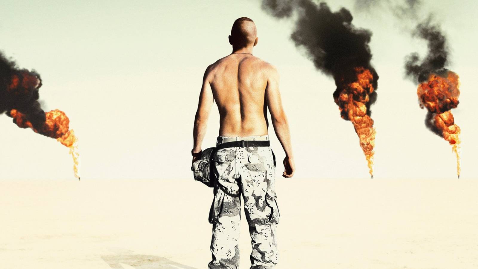 A shirtless soldier in the desert with his back to the camera in the Jarhead poster