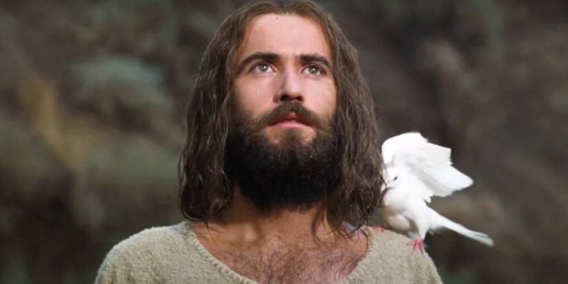 Jesus Christ (Brian Deacon) looks upward with the Holy Spirit resembling a dove perched on his shoulder in 'Jesus' (1979)