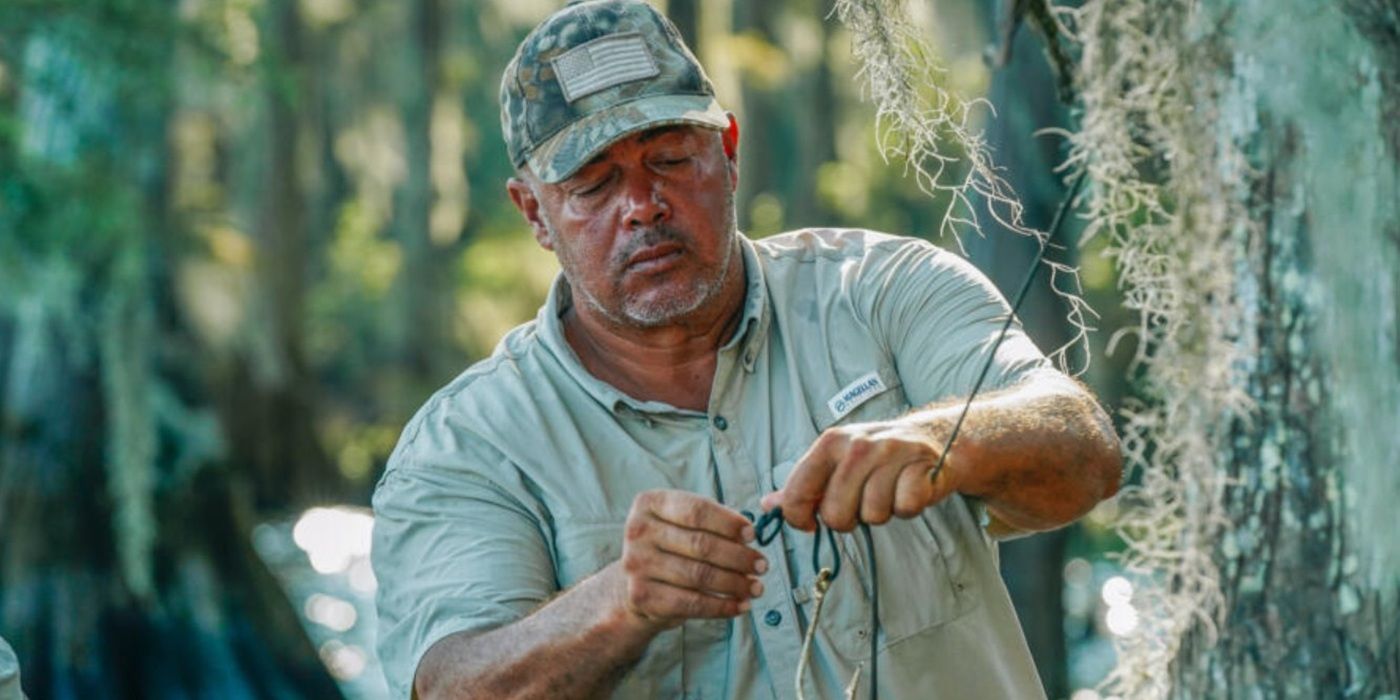 Joey Edgar works with a hook and line outdoors in Swamp People.