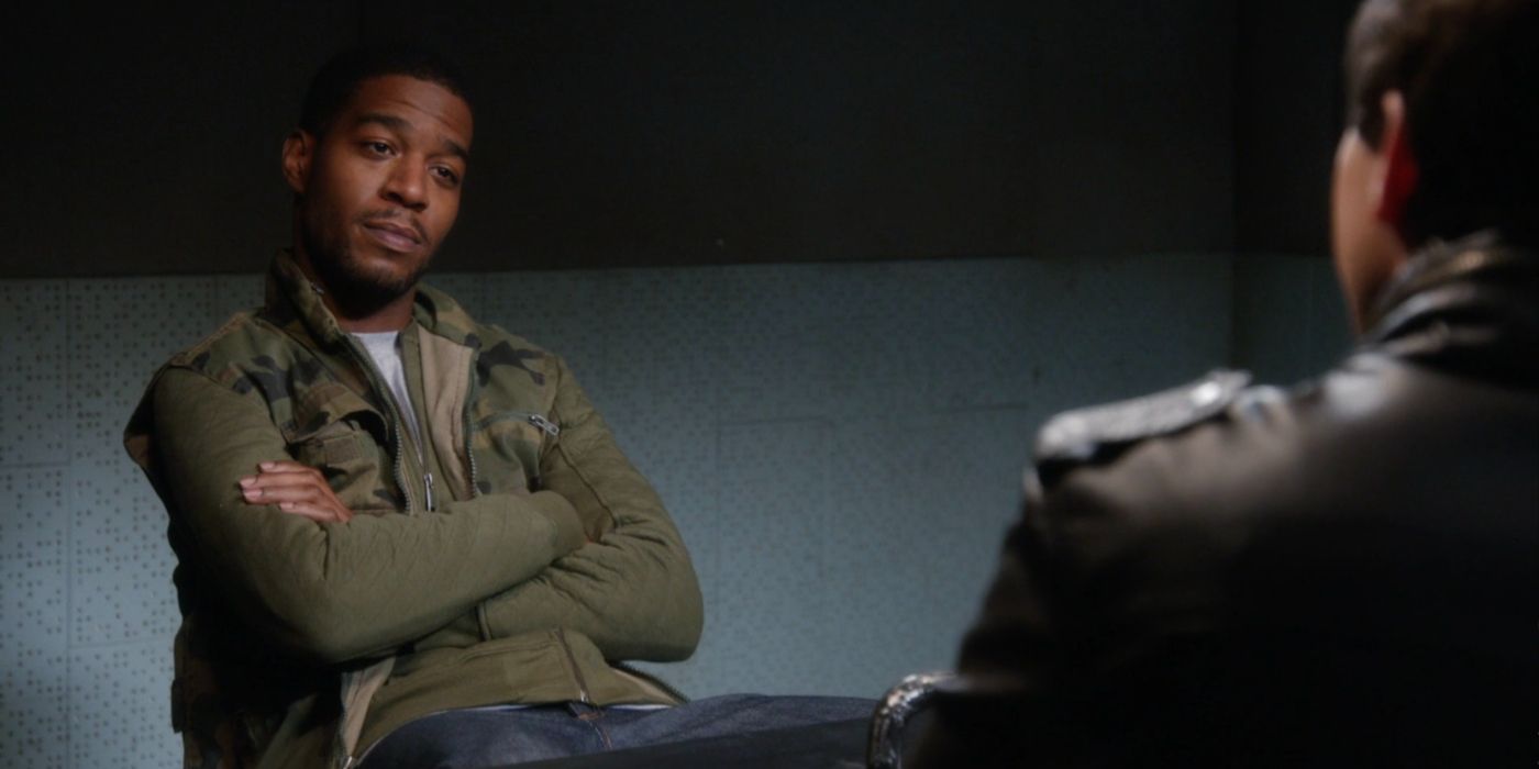 Dustin Whitman (played by Kid Cudi) sitting across from Jake Peralta (played by Andy Samberg), though you can only see some of Jake's back in "Brooklyn-Nine-Nine."