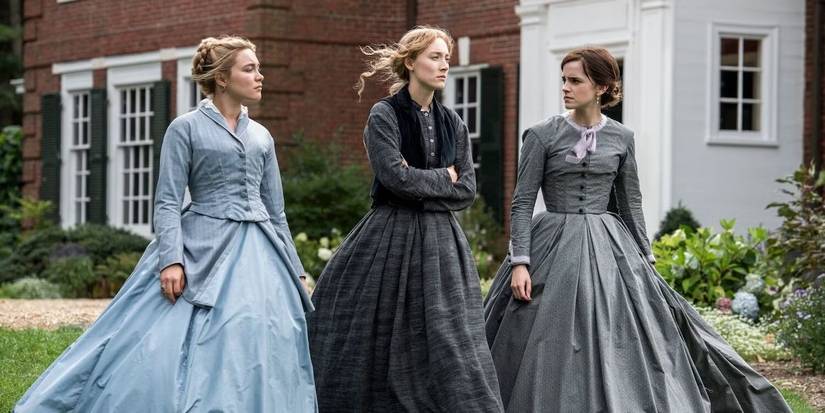Florence Pugh, Saoirse Ronan, and Emma Watson stand outside and look somber in 'Little Women'.