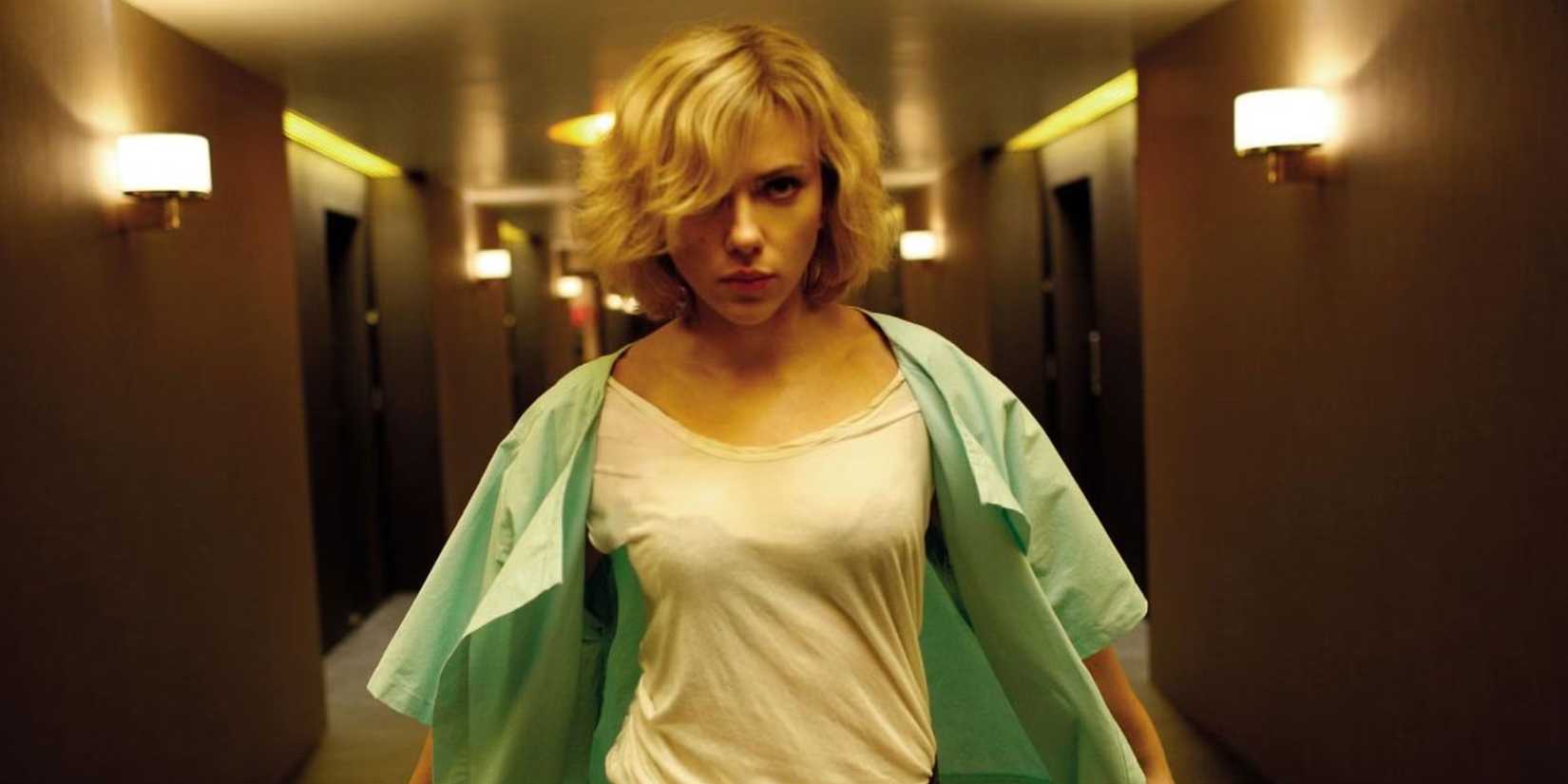 Lucy (Scarlett Johansson) running down a hallway in 'Lucy'