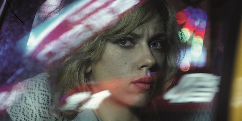 Scarlett Johansson in Lucy reflected in a car window